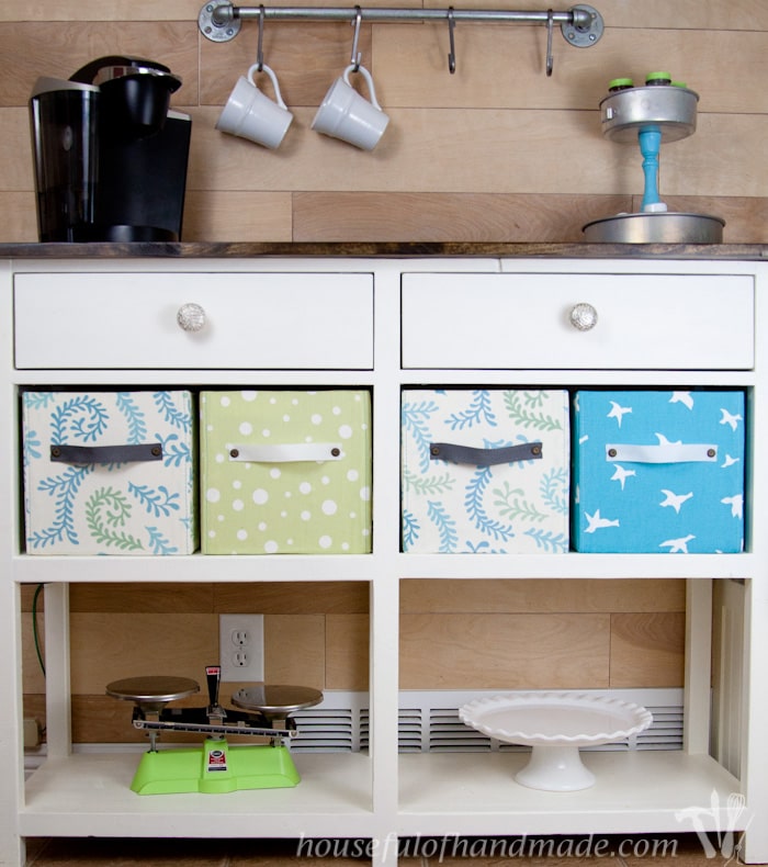 Coffee bar station shown with diy fabric storage boxes. 